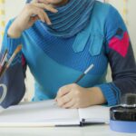 Writer working at a desk, representing crafting an author page bio that turns readers into subscribers